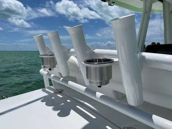 Slide: The Image of Rod holders on a 2021 Regulator 34 boat against a scenic ocean backdrop. - 17