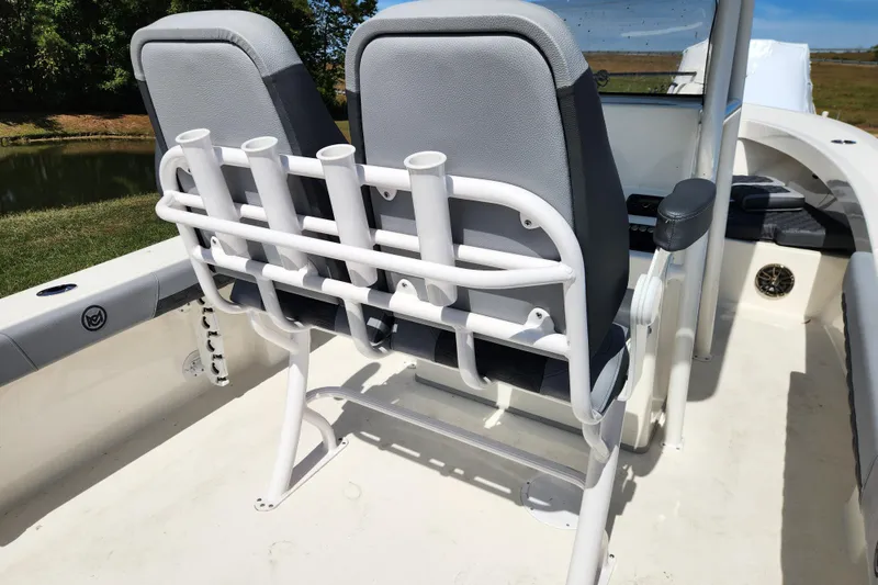 Slide: The Image of 2025 May-Craft 245 Offshore CC boat interior with dual seats and rod holders. - 14