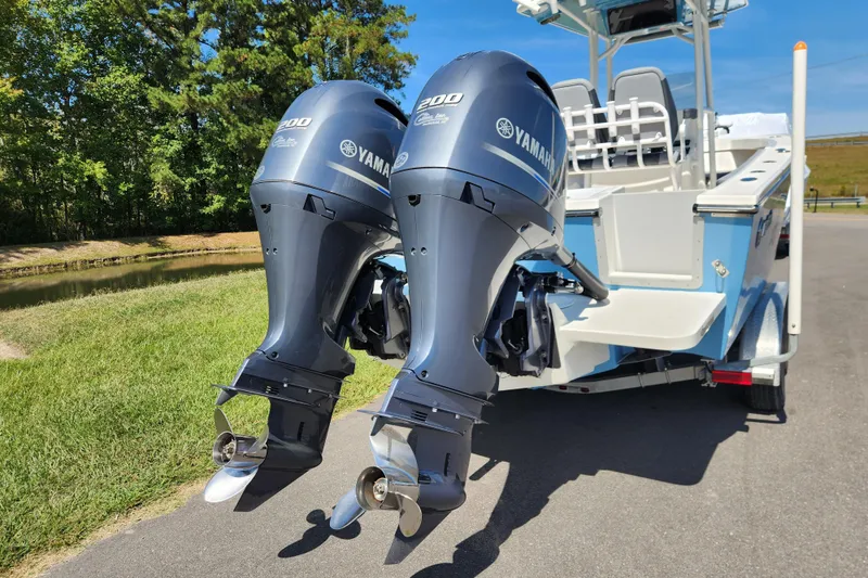 Slide: The Image of 2025 May-Craft 245 Offshore CC with dual Yamaha 200 engines on a trailer. - 3