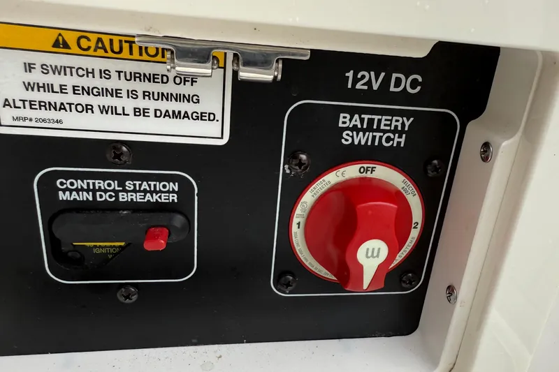 Slide: The Image of Battery switch panel on 2021 Sea Ray SDX 250 boat with caution warning. - 12