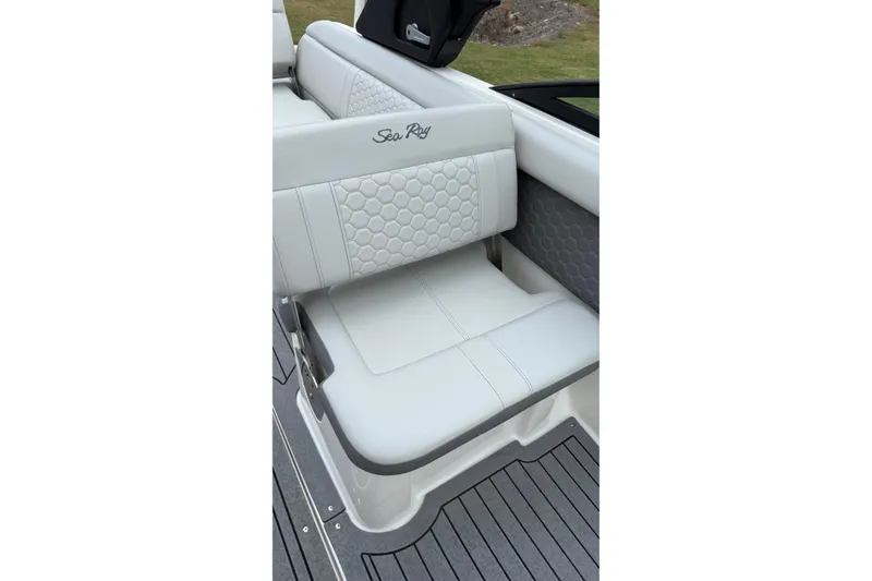 Slide: The Image of 2021 Sea Ray SDX 250 boat interior seating with elegant white upholstery. - 6