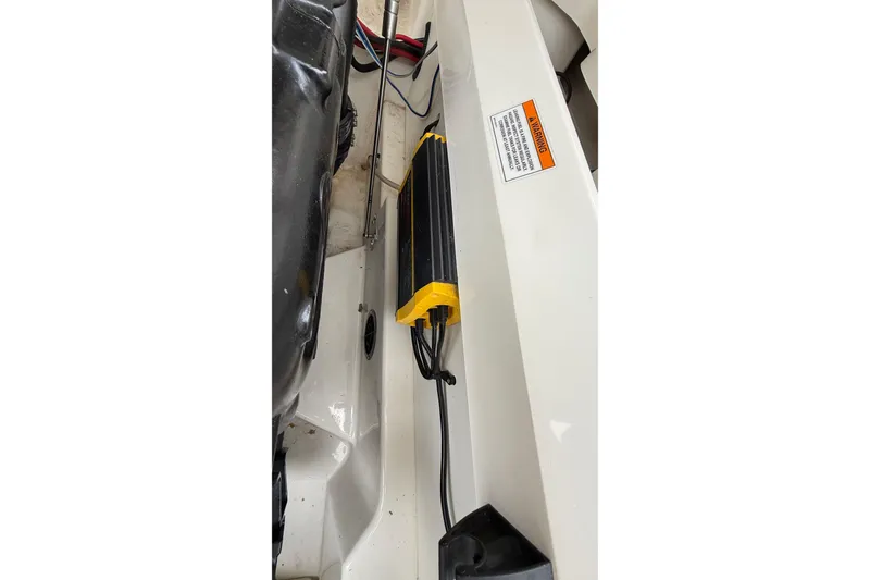 Slide: The Image of Engine compartment of 2021 Sea Ray SDX 250 with visible wiring and warning label. - 9