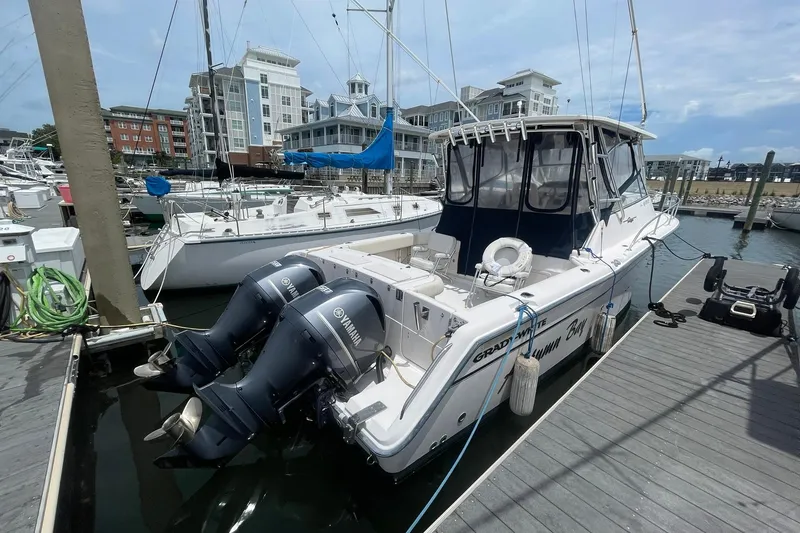 The Image of 2003 Grady-White Express 330 boat docked with twin Yamaha engines. - 0