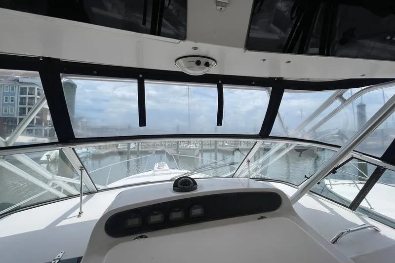 Slide: The Image of 2003 Grady-White Express 330 boat helm view, overlooking marina with clear skies. - 10