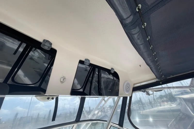 Slide: The Image of 2003 Grady-White Express 330 boat interior, featuring windows and a speaker system. - 11