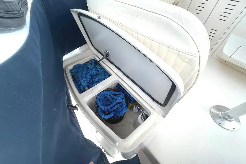 Slide: The Image of Storage compartment on 2003 Grady-White Express 330 boat with blue ropes inside. - 14