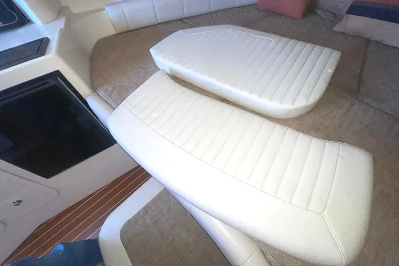Slide: The Image of Interior seating of 2003 Grady-White Express 330 boat, featuring white cushioned seats. - 15