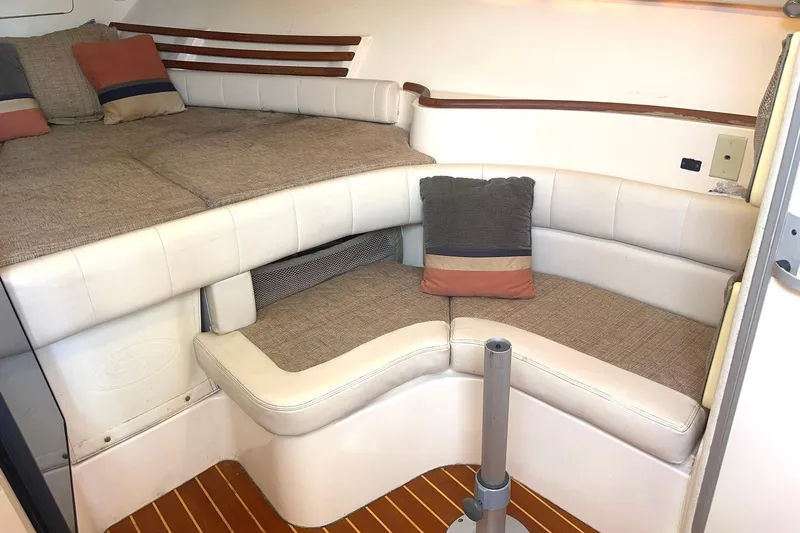 Slide: The Image of 2003 Grady-White Express 330 cabin interior with cushioned seating and pillows. - 20