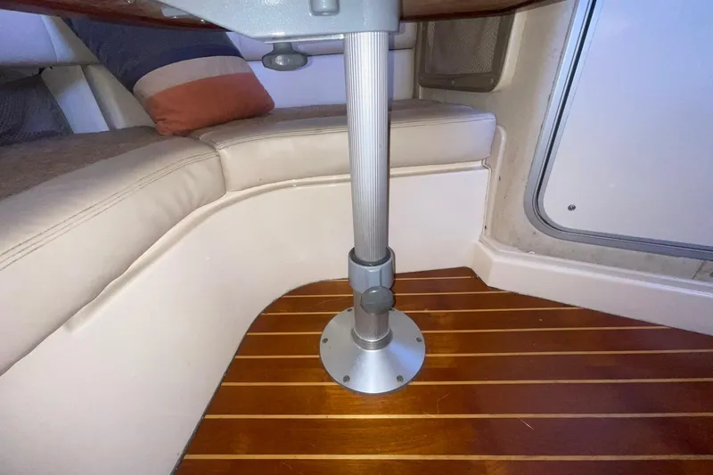 Slide: The Image of Interior of 2003 Grady-White Express 330 boat with wooden flooring and cushioned seating. - 22