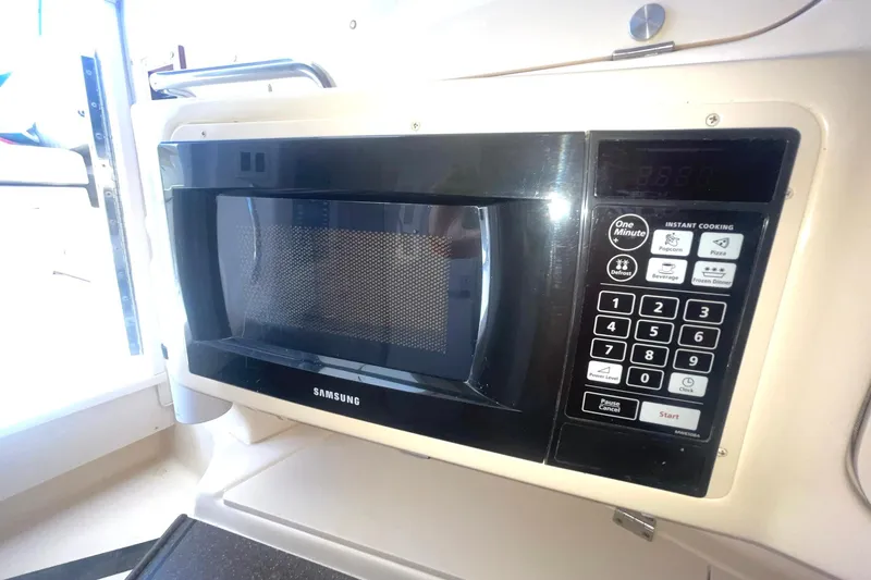 Slide: The Image of Samsung microwave inside a 2003 Grady-White Express 330 boat kitchen area. - 27