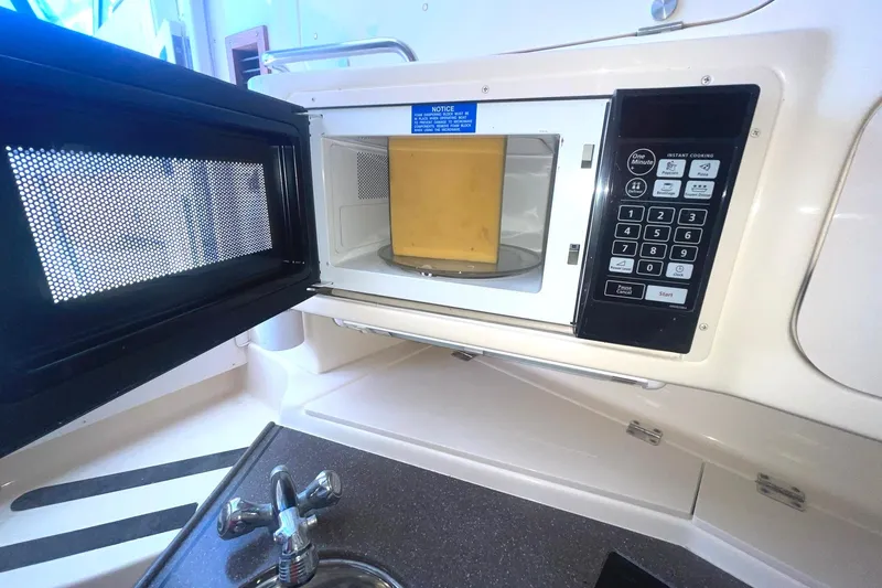 Slide: The Image of Microwave with cheese inside on 2003 Grady-White Express 330 boat kitchen. - 28