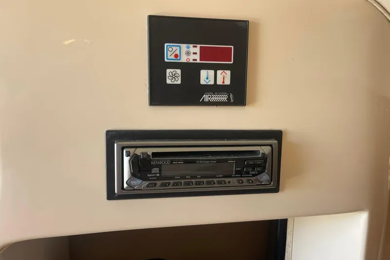 Slide: The Image of 2003 Grady-White Express 330 control panel with Kenwood stereo system. - 31