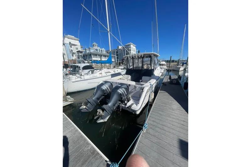 Slide: The Image of 2003 Grady-White Express 330 boat docked with dual outboard engines. - 39