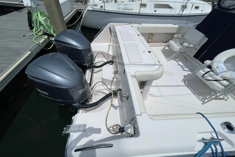 Slide: The Image of 2003 Grady-White Express 330 boat with dual Yamaha outboard motors docked at marina. - 4