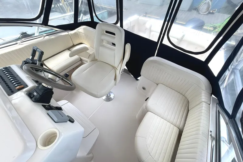 Slide: The Image of 2003 Grady-White Express 330 boat interior with white seating and steering console. - 7