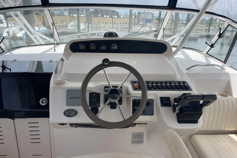 Slide: The Image of Helm of 2003 Grady-White Express 330 boat with steering wheel and controls. - 8