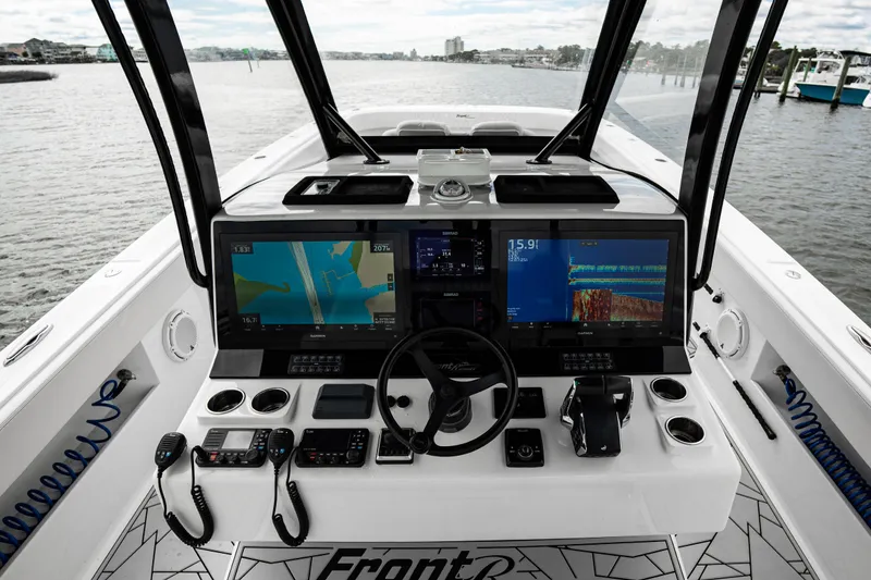 Slide: The Image of 2024 Front Runner 37 Catamaran helm with advanced navigation displays and controls. - 14
