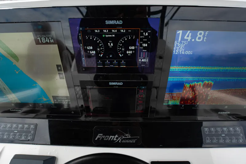 Slide: The Image of Dashboard of 2024 Front Runner 37 Catamaran with Simrad and Garmin displays. - 16