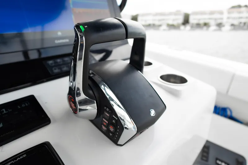 Slide: The Image of Throttle control on 2024 Front Runner 37 Catamaran dashboard with navigation display. - 17