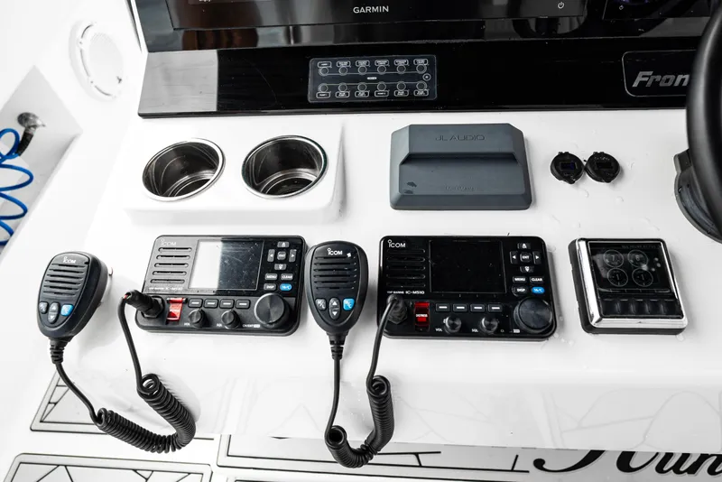 Slide: The Image of 2024 Front Runner 37 Catamaran dashboard with communication equipment and controls. - 18