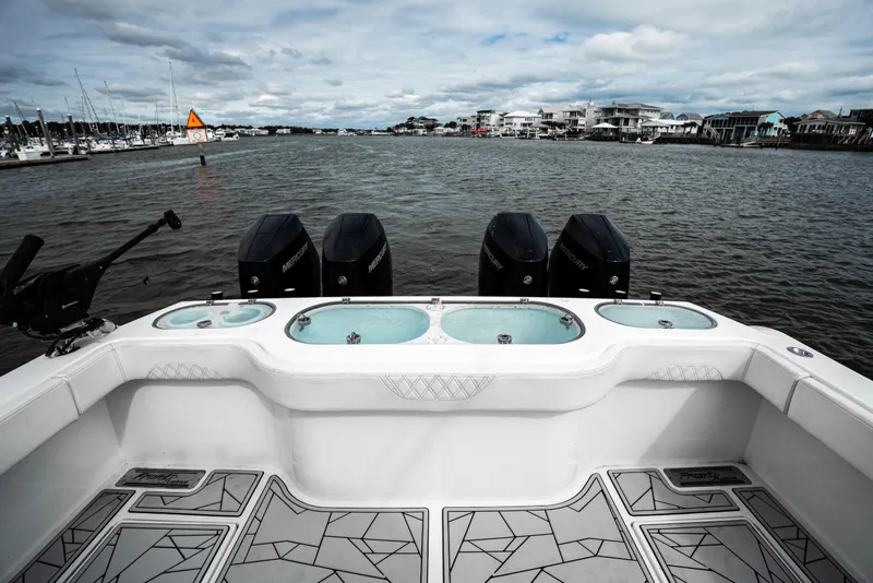 Slide: The Image of 2024 Front Runner 37 Catamaran with four Mercury engines on a calm waterway. - 22