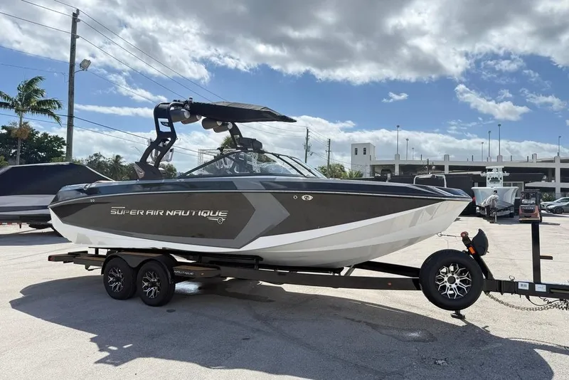 The Image of 2018 Nautique Super Air Nautique G25 Coastal Edition on trailer, parked outdoors. - 1