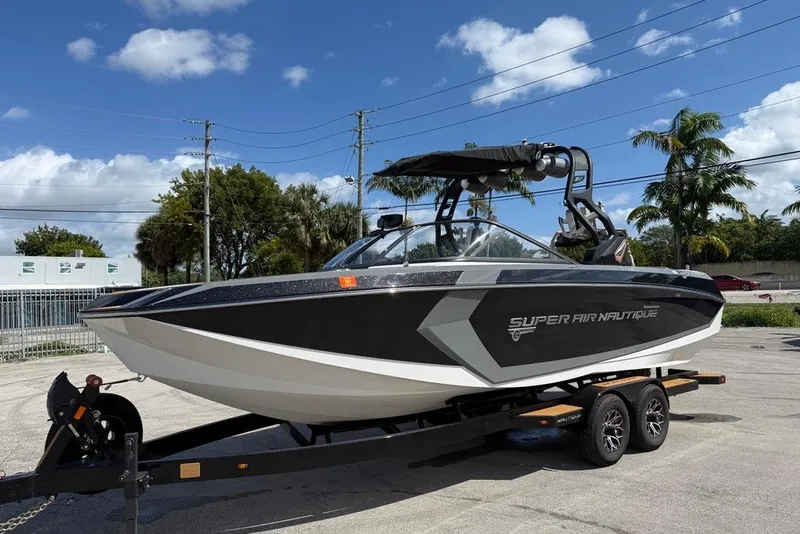 Slide: The Image of 2018 Nautique Super Air Nautique G25 Coastal Edition boat on trailer, sunny day. - 3