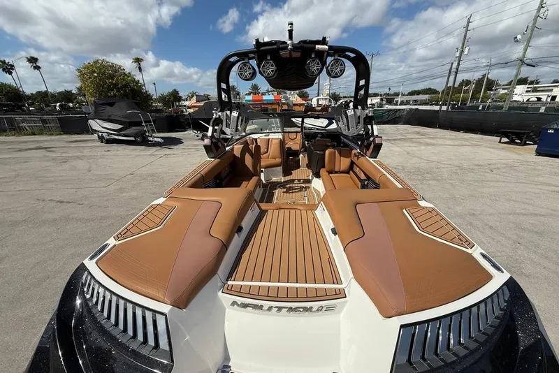Slide: The Image of 2018 Nautique Super Air Nautique G25 Coastal Edition boat with tan seating and sleek design. - 7