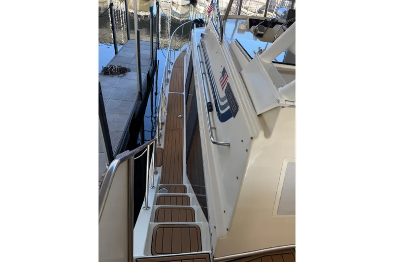 Slide: The Image of 1990 Blue Water 42 Coastal Cruiser with teak deck, docked at marina. - 10