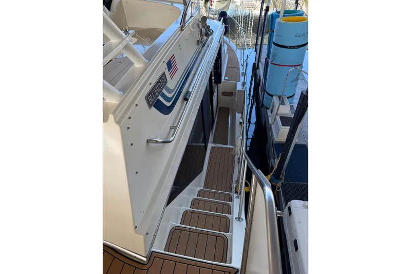 Slide: The Image of 1990 Blue Water 42 Coastal Cruiser boat with teak deck and American flag detail. - 11