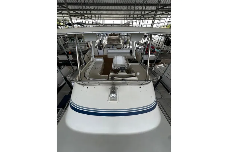 Slide: The Image of 1990 Blue Water 42 Coastal Cruiser in covered marina, showcasing deck and helm. - 13