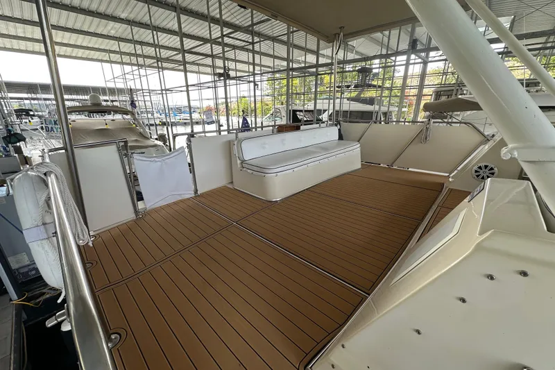 Slide: The Image of 1990 Blue Water 42 Coastal Cruiser with spacious deck and seating under covered marina. - 18
