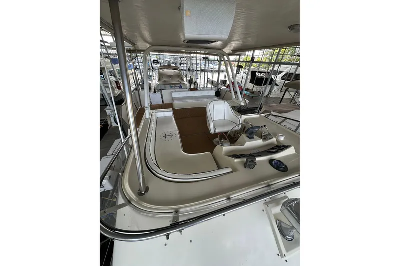 Slide: The Image of 1990 Blue Water 42 Coastal Cruiser interior with helm and seating area. - 19