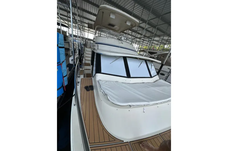 Slide: The Image of 1990 Blue Water 42 Coastal Cruiser docked under a covered marina. - 2