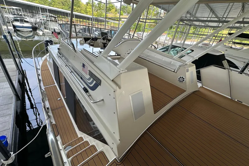 Slide: The Image of 1990 Blue Water 42 Coastal Cruiser docked, featuring spacious deck and sleek design. - 20
