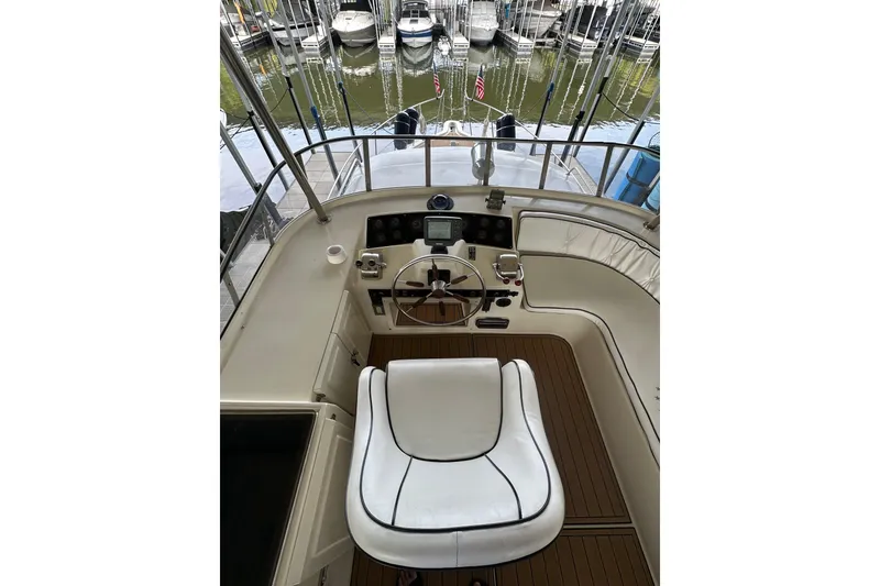 Slide: The Image of Cockpit of 1990 Blue Water 42 Coastal Cruiser with helm and seating, docked at marina. - 22