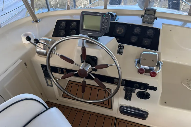 Slide: The Image of Helm of 1990 Blue Water 42 Coastal Cruiser with steering wheel and navigation controls. - 23