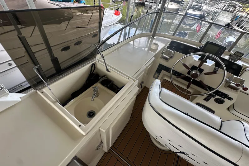 Slide: The Image of 1990 Blue Water 42 Coastal Cruiser helm with sink and steering wheel. - 25
