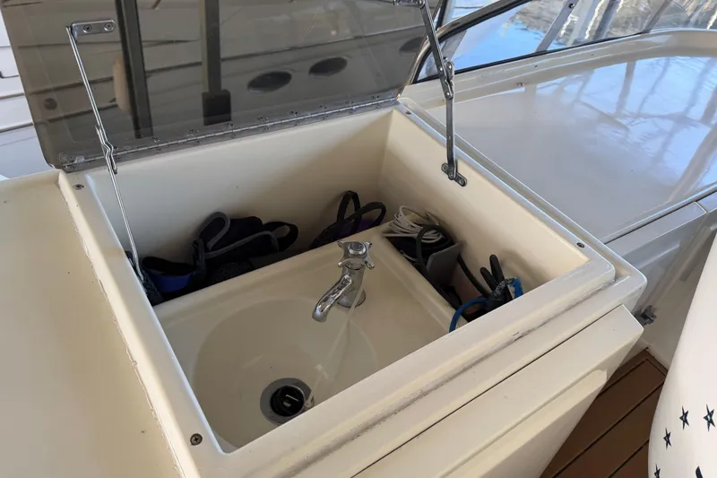 Slide: The Image of Open sink compartment on 1990 Blue Water 42 Coastal Cruiser yacht deck. - 26