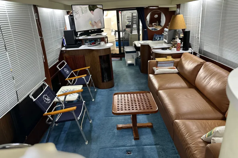 Slide: The Image of Interior of 1990 Blue Water 42 Coastal Cruiser with leather sofa and nautical decor. - 31