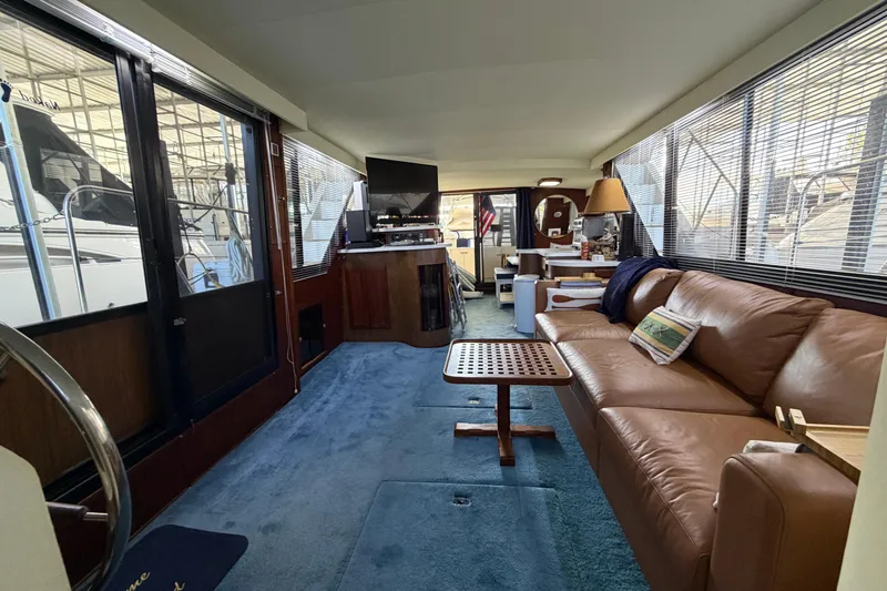Slide: The Image of Interior of 1990 Blue Water 42 Coastal Cruiser with leather sofa and nautical decor. - 35