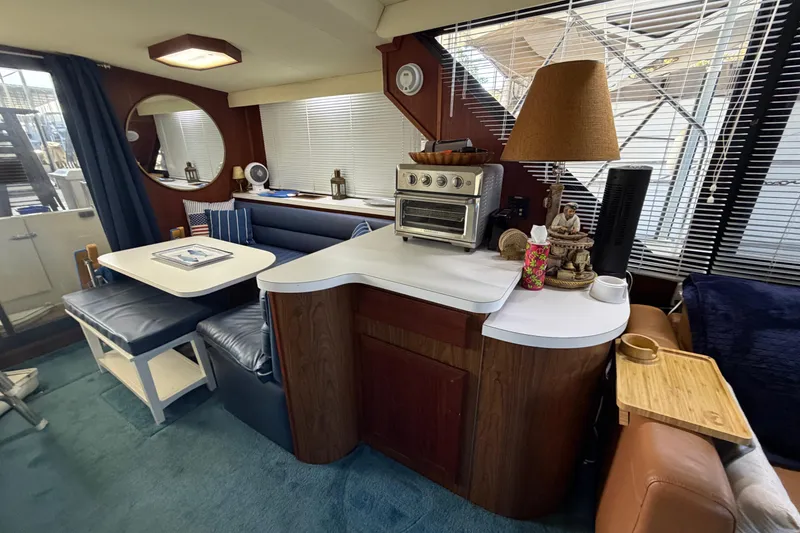 Slide: The Image of Interior of 1990 Blue Water 42 Coastal Cruiser with dining area and kitchen amenities. - 36