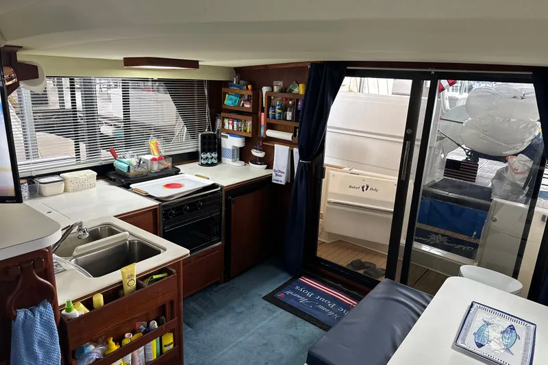 Slide: The Image of Interior of 1990 Blue Water 42 Coastal Cruiser with kitchen and seating area. - 39