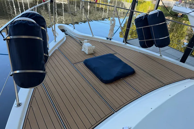 Slide: The Image of Deck of 1990 Blue Water 42 Coastal Cruiser with fenders and wooden flooring. - 4