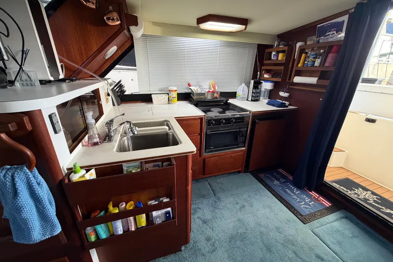 Slide: The Image of Interior of 1990 Blue Water 42 Coastal Cruiser kitchen with sink, stove, and storage. - 40