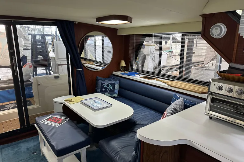 Slide: The Image of Interior of 1990 Blue Water 42 Coastal Cruiser with cozy seating and nautical decor. - 44
