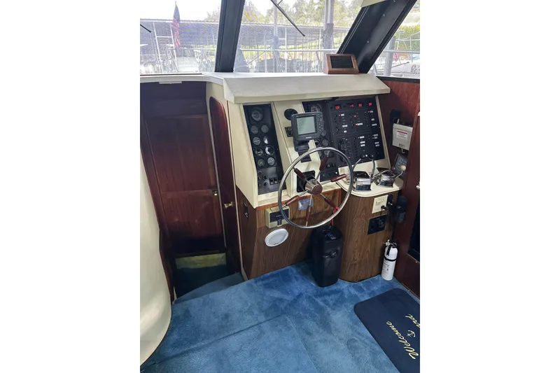 Slide: The Image of Helm of 1990 Blue Water 42 Coastal Cruiser with steering wheel and control panel. - 46