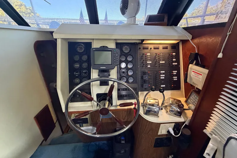 Slide: The Image of Cockpit of 1990 Blue Water 42 Coastal Cruiser with steering wheel and control panels. - 47