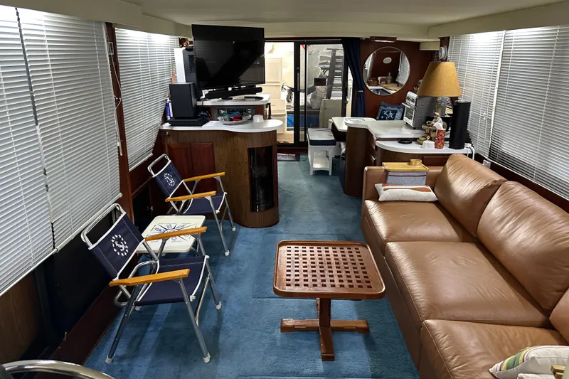 Slide: The Image of Interior of 1990 Blue Water 42 Coastal Cruiser with leather sofa and nautical decor. - 48