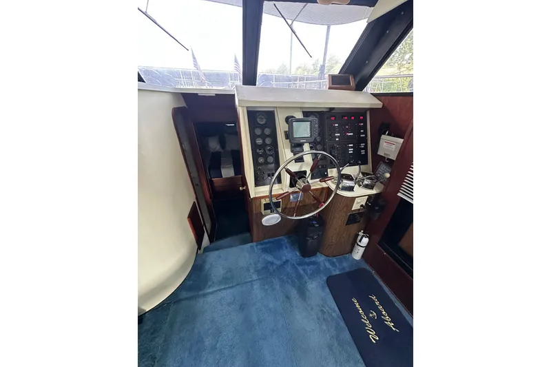 Slide: The Image of Interior helm of 1990 Blue Water 42 Coastal Cruiser with steering wheel and control panel. - 49